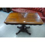 A Victorian rosewood fold over card table