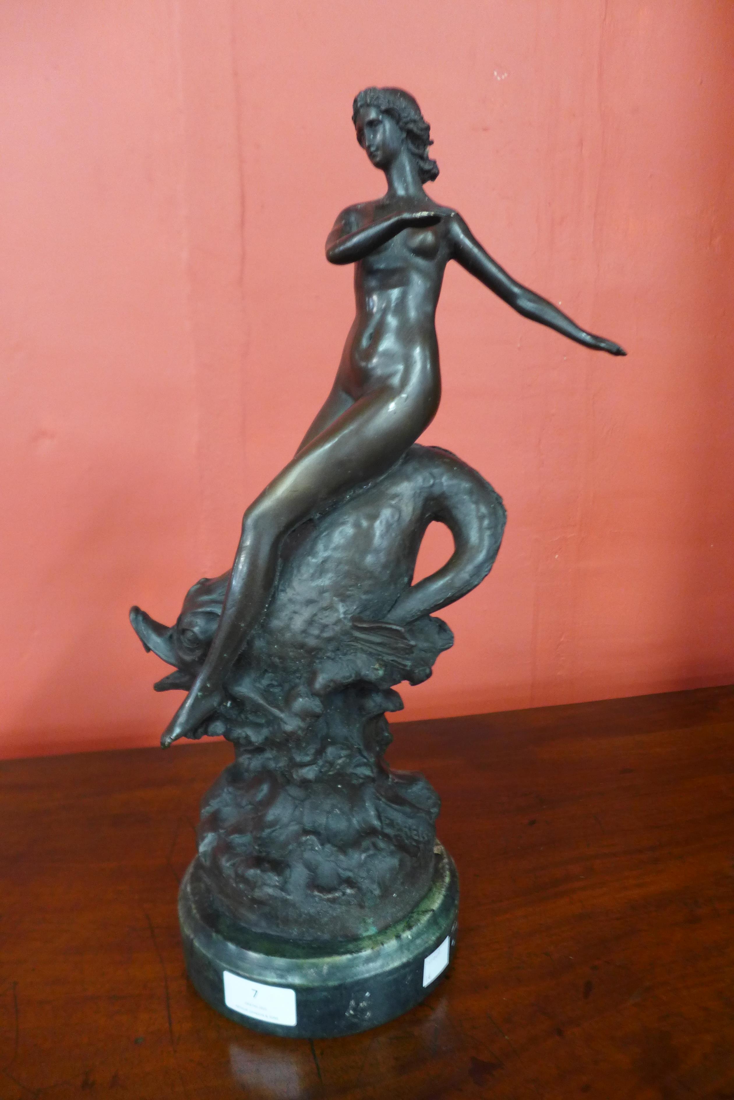 A bronze figure of a female nude, on marble socle