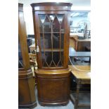 A burr walnut freestanding corner cabinet