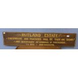 A painted wooden Rutland Estate sign