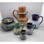 A Bourne Denby puzzle jug, tobacco jar and four Lovatts stoneware jugs