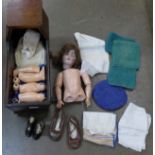 A circa 1900 doll, the head numbered 136/7, clothing and a pair of shoes, and a pair of Little