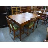 A McIntosh teak extending dining table and four chairs