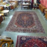 A Persian hand knotted wool blue ground Kashan rug, 394 x 287cms