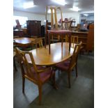 A teak extending dining table and a set of six Nathan teak dining chairs