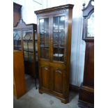 A George III style Ipswich oak freestanding corner cabinet