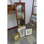 An Edward VII carved walnut mirror, an etching of flowers and two other pictures