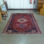 An eastern red ground rug, 289 x 202cms