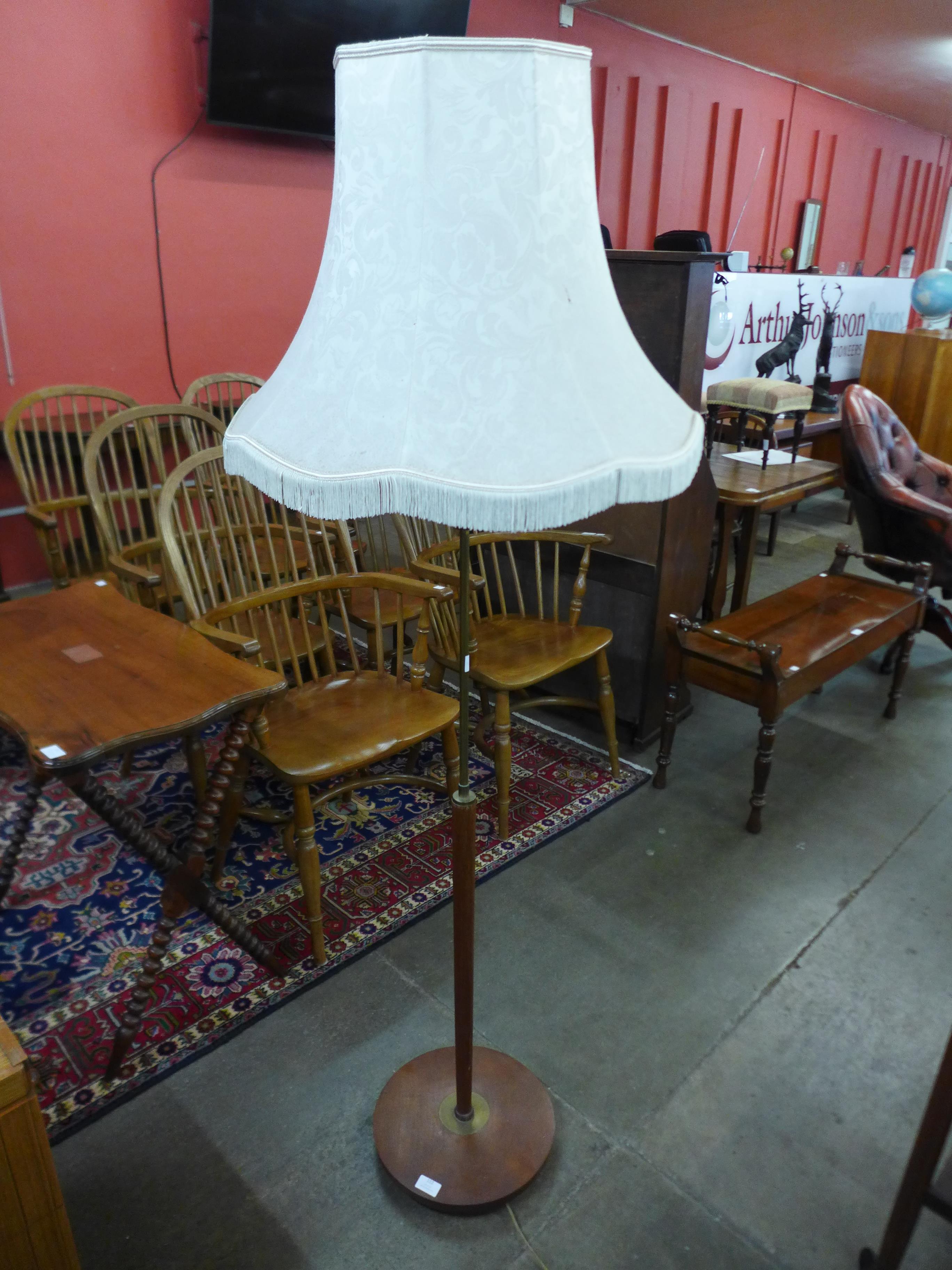 A teak standard lamp