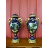 A pair of large Sevres style cobalt blue porcelain and and gilt metal two handled garnitures,