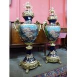A pair of large Sevres style cobalt blue porcelain and gilt metal two handled garnitures, 107cms h