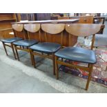 A set of four teak dining chairs