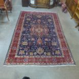 A Persian hand knotted wool blue ground Tabriz rug