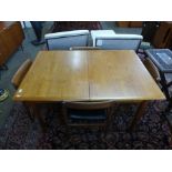 A Dalescraft teak extending dining table and four chairs