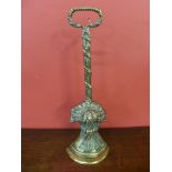 A Victorian brass lead based door porter, depicting a wheat sheaf