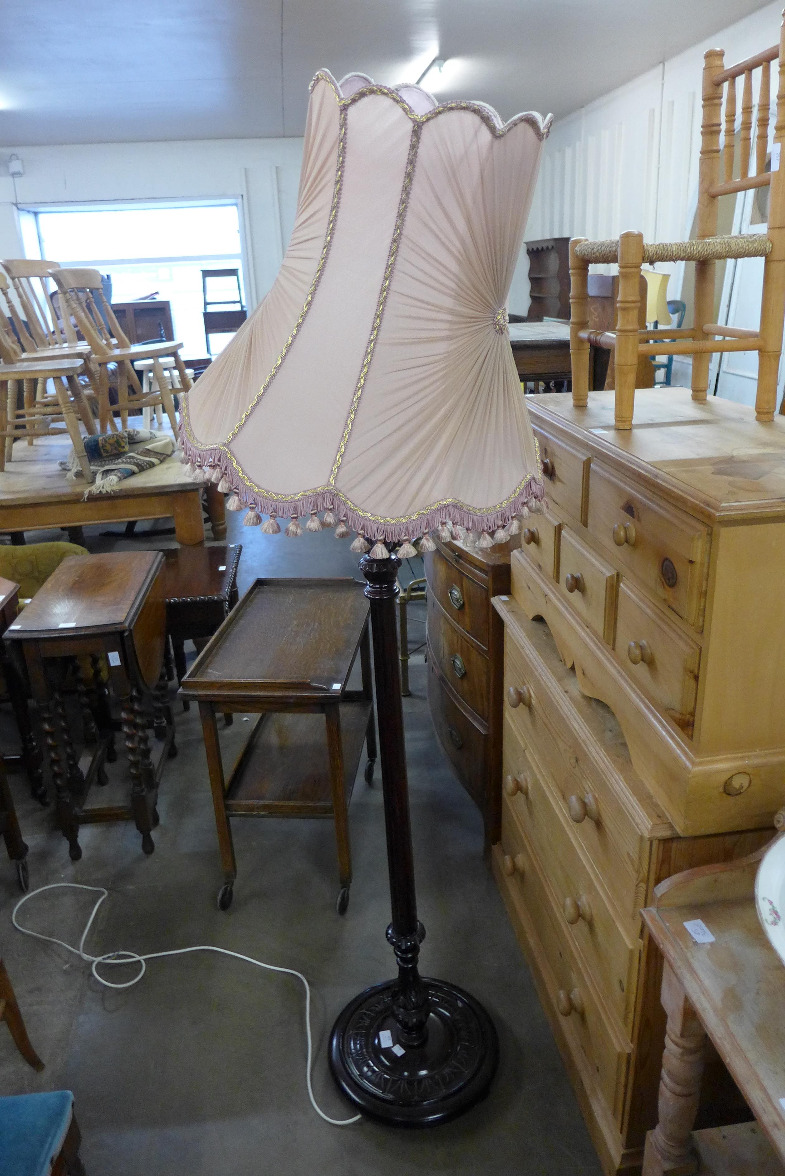 A carved mahogany standard lamp