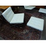 A Barcelona style chrome and white faux leather chair and stool