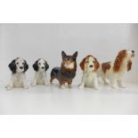 Four Sylvac dogs and one Beswick Black Prince dog figure