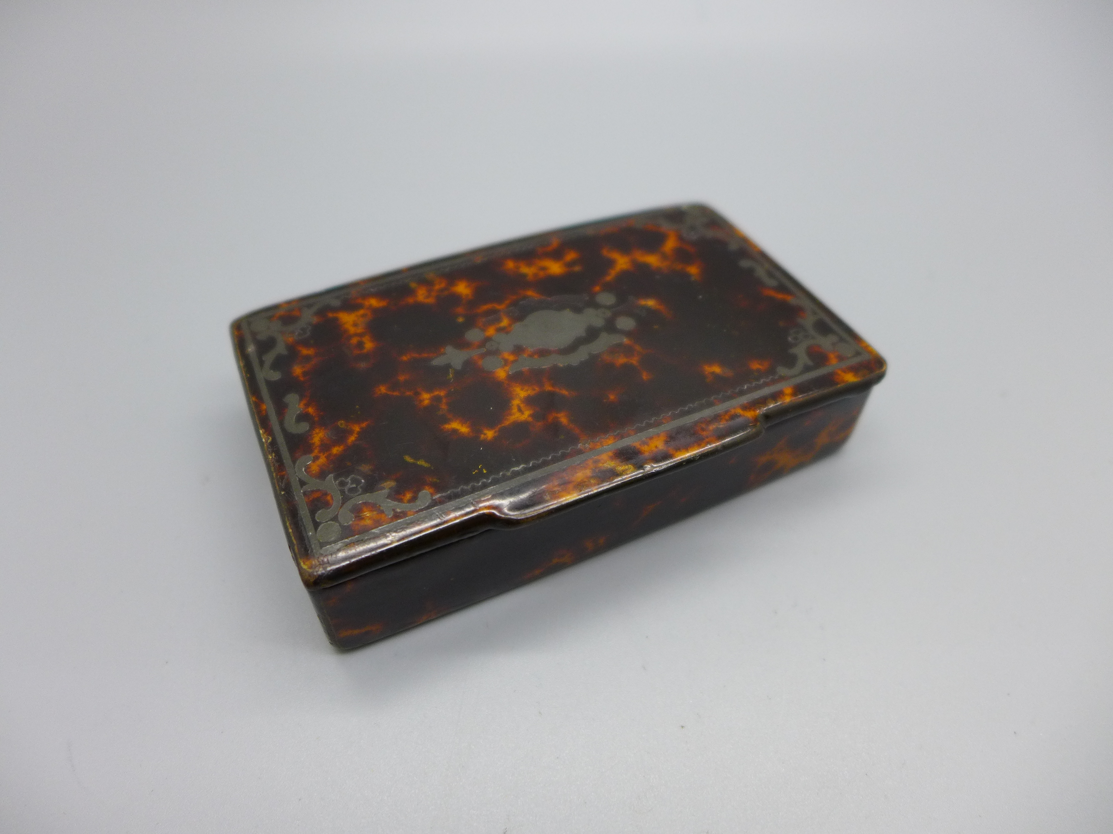 A 19th Century papier-mache and faux tortoiseshell snuff box