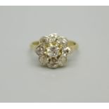 An 18ct gold, platinum set diamond cluster ring, 2.5g, L