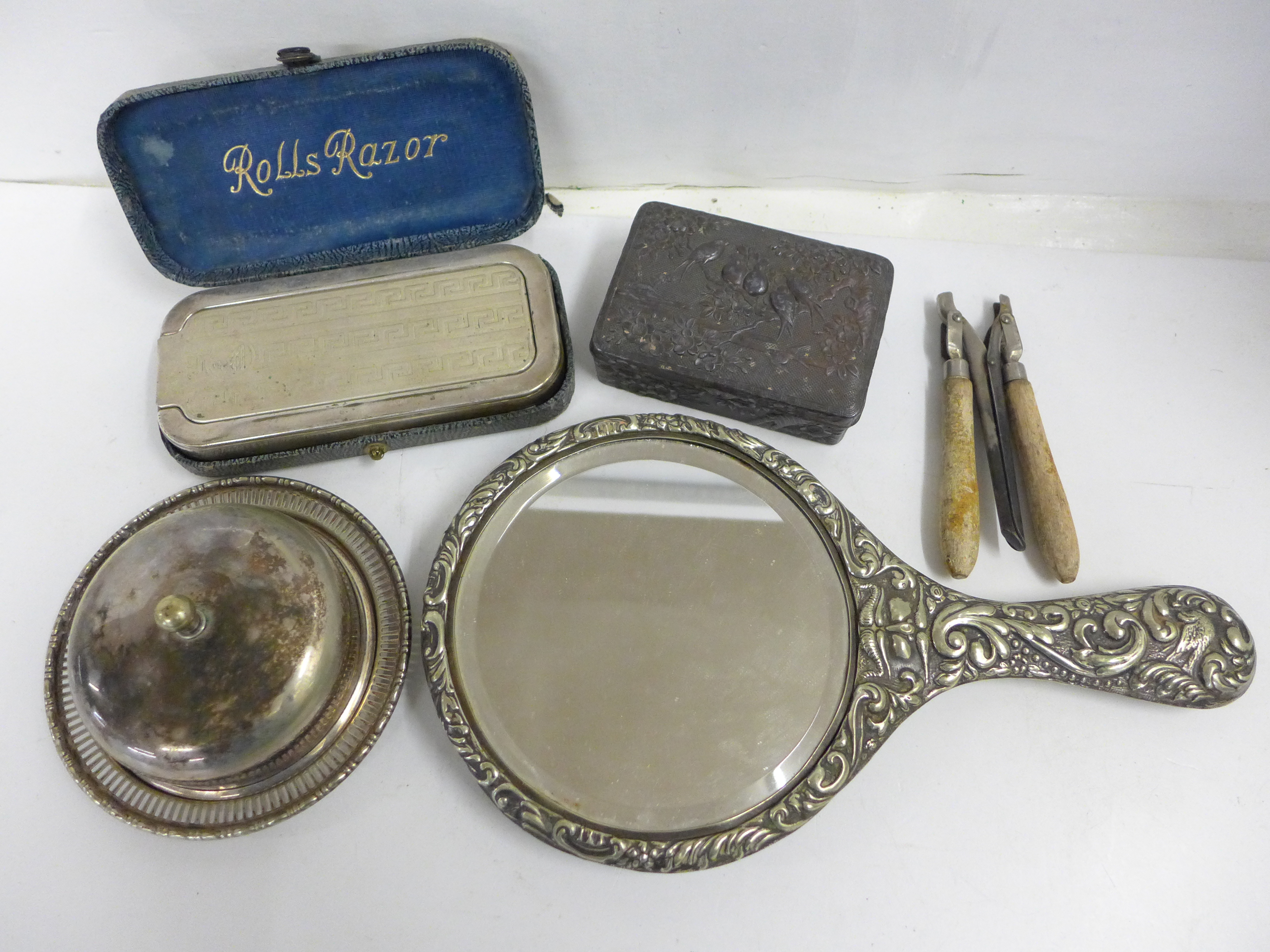 A plated hand mirror, a razor set, curling tongs, a metal box and a silver plated covered dish