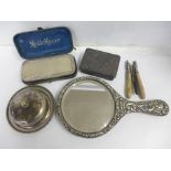 A plated hand mirror, a razor set, curling tongs, a metal box and a silver plated covered dish