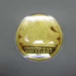 A 24ct gold plated medallion celebrating the 1953 Coronation of H.M. The Queen with certificate of