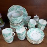 A circa 1900 tea service, eleven cups, eleven saucers, eleven side plates, cream, sugar and two