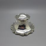 An early 20th Century silver inkwell, worn Chester hallmark, diameter of base 9cm