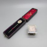 A Victorian stick pin with gold applied decoration and case and a silver stamp box, Royal Mail,