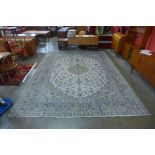 A Persian hand knotted wool cream ground Kashan rug, 397 x 296cms