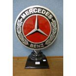 A reproduction Mercedes-Benz metal sign