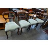 A set of four Victorian rosewood balloon back dining chairs