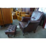 A chestnut brown leather armchair and footstool