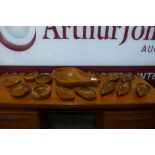 A pear shaped teak fruit bowl, eight other pear shaped bowls and other bowls