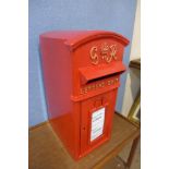 A red metal Post Office post box, with key