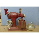 A vintage Crypto red metal coffee grinder