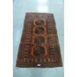 An eastern terracotta ground rug, 182 x 108cms