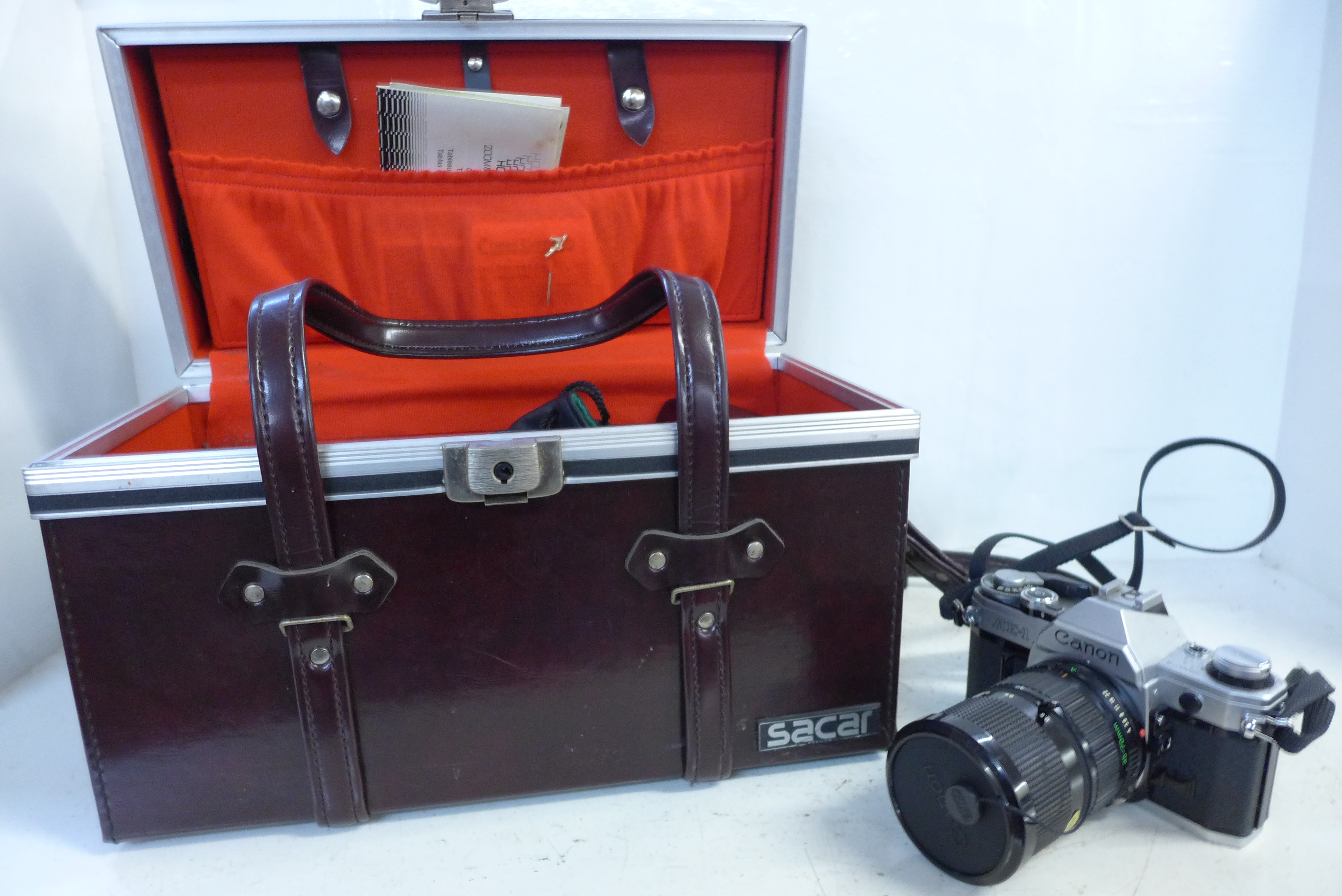 A Canon AE-1 camera with box and accessories including lenses, filters, etc.