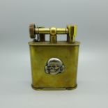 An early 20th Century brass table lighter mounted with Totenkopf head, skull and crossbones or '