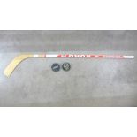 A signed Koho ice hockey stick with two pucks
