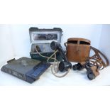 Military related items; a field telephone in metal case, a pair of binoculars and a WWII Sherman