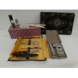 A snakeskin cased travel razor, a travel manicure set, evening purse, etc.