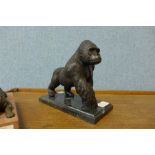 A bronze figure of a gorilla, on black marble socle