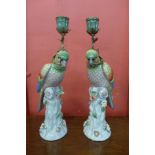 A pair of French style porcelain and gilt metal mounted figural parrot candlesticks