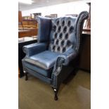 A blue leather Chesterfield wingback armchair