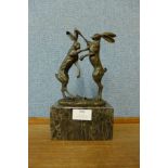 A bronze figure of boxing hares, on black marble socle