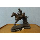 A bronze figure of a horse and jockey, on black marble plinth