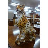 A life sized glazed porcelain figure of a leopard and two cubs