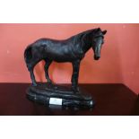 A bronze figure of a horse, on black marble socle